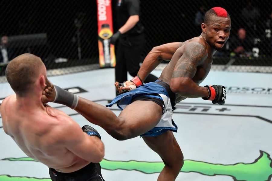 Marc Diakiese landing a head kick in a professional MMA fight